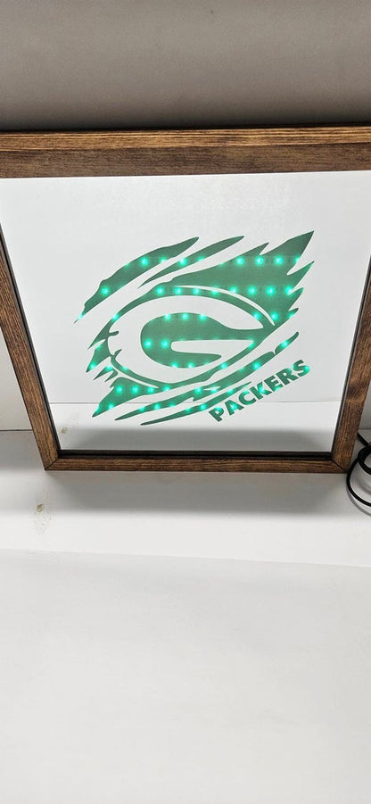 Packers Tear Through Mirror Light Box